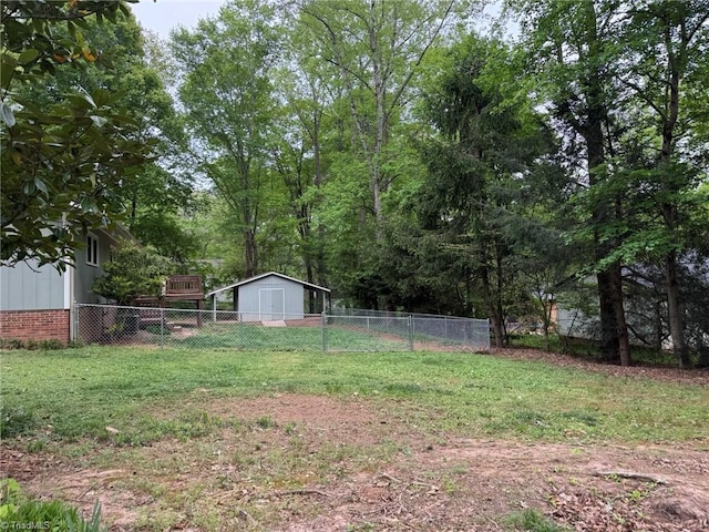 view of yard with a storage shed, fence, and an outdoor structure
