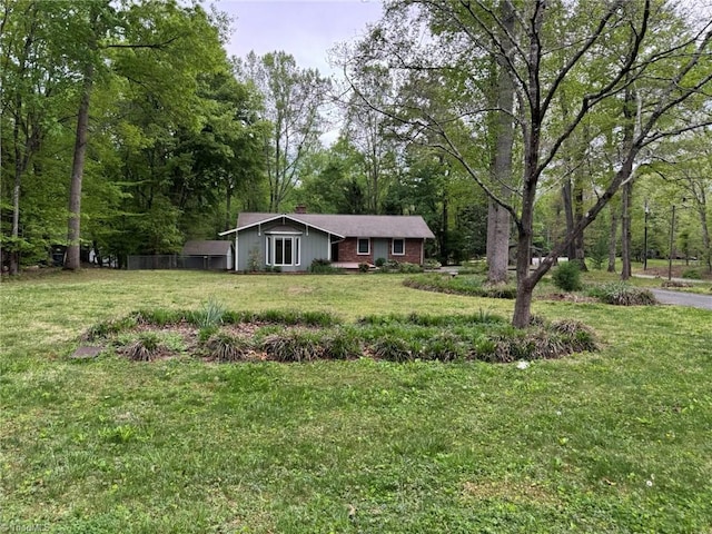 view of front of property featuring a chimney and a front yard