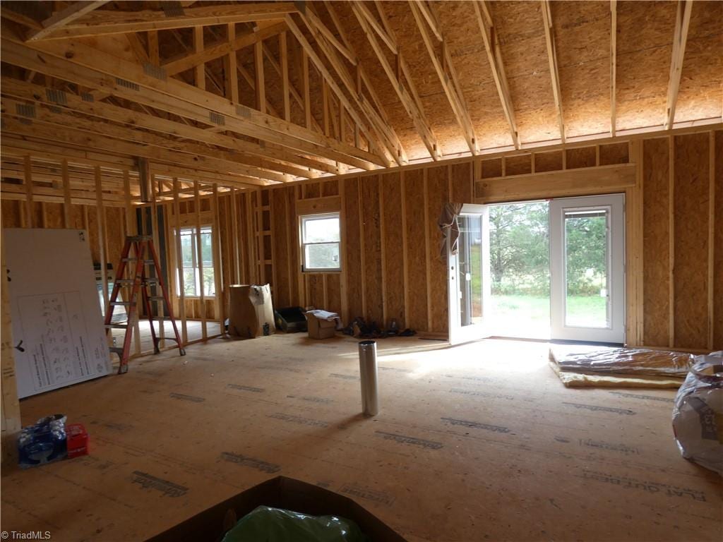 misc room featuring high vaulted ceiling and plenty of natural light