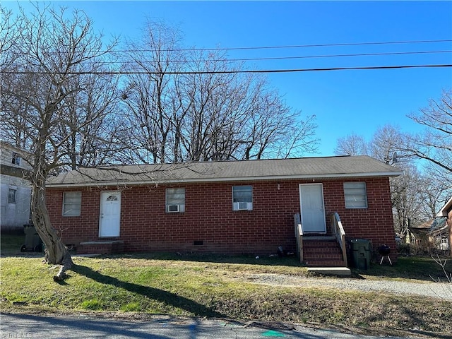 view of front facade with a front yard, crawl space, brick siding, and entry steps