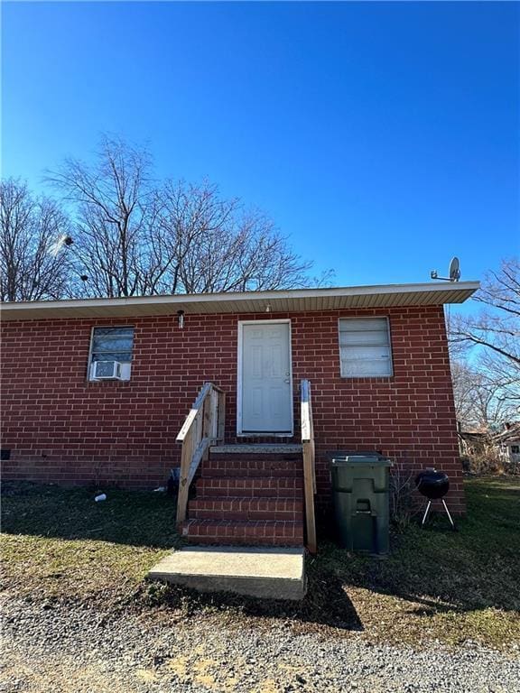 view of front of home featuring crawl space and brick siding