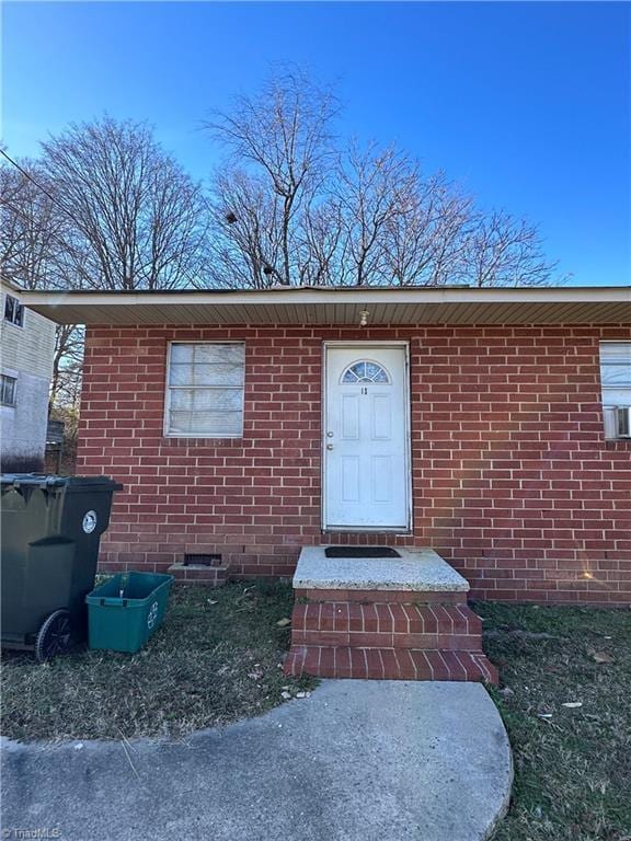 entrance to property with brick siding