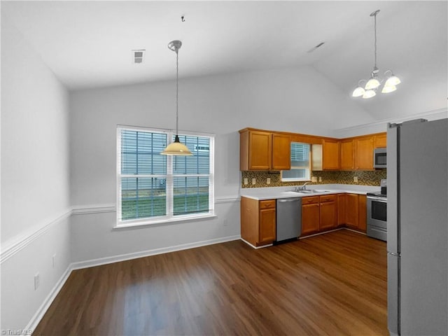 615 Walnut Crossing Dr, Whitsett, NC 27377 - kitchen with appliances with stainless steel finishes, a chandelier, dark wood-type flooring, light countertops, and high vaulted ceiling