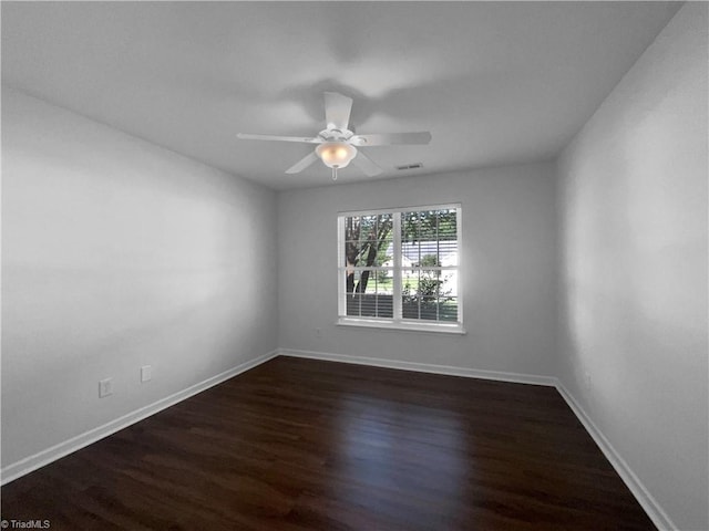 615 Walnut Crossing Dr, Whitsett, NC 27377 - spare room featuring dark wood-style floors, baseboards, and a ceiling fan
