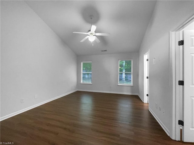 615 Walnut Crossing Dr, Whitsett, NC 27377 - spare room with vaulted ceiling, ceiling fan, dark wood-style flooring, and baseboards