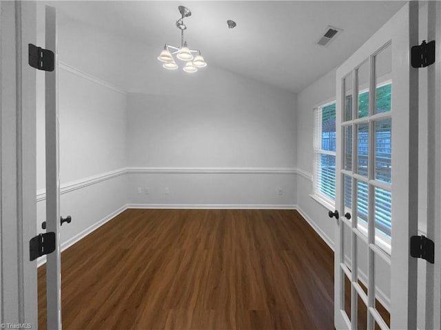 615 Walnut Crossing Dr, Whitsett, NC 27377 - empty room with a chandelier, dark wood-style flooring, baseboards, and lofted ceiling