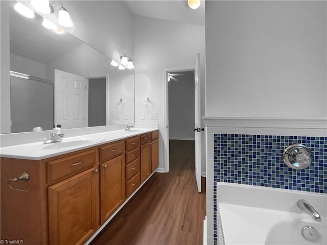 615 Walnut Crossing Dr, Whitsett, NC 27377 - bathroom featuring wood finished floors, double vanity, a bathtub, and a shower