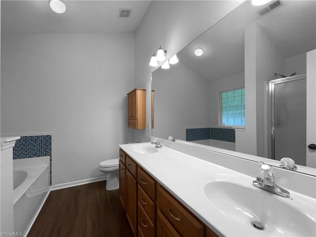 615 Walnut Crossing Dr, Whitsett, NC 27377 - full bath with a garden tub, double vanity, a shower stall, wood finished floors, and lofted ceiling