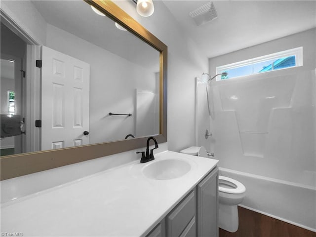 615 Walnut Crossing Dr, Whitsett, NC 27377 - bathroom with toilet, vanity, wood finished floors, and  shower combination