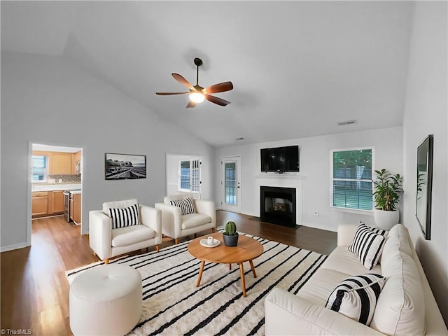 615 Walnut Crossing Dr, Whitsett, NC 27377 - living room featuring light wood finished floors, high vaulted ceiling, a ceiling fan, and a fireplace with flush hearth