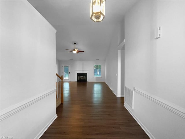 615 Walnut Crossing Dr, Whitsett, NC 27377 - hallway with dark wood-style floors, stairs, baseboards, and vaulted ceiling