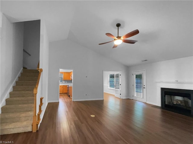 615 Walnut Crossing Dr, Whitsett, NC 27377 - unfurnished living room with ceiling fan, dark wood-style flooring, stairs, a fireplace with flush hearth, and baseboards