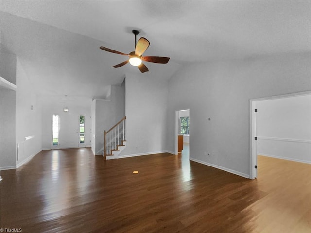 615 Walnut Crossing Dr, Whitsett, NC 27377 - unfurnished living room with healthy amount of natural light, high vaulted ceiling, ceiling fan, wood finished floors, and stairway