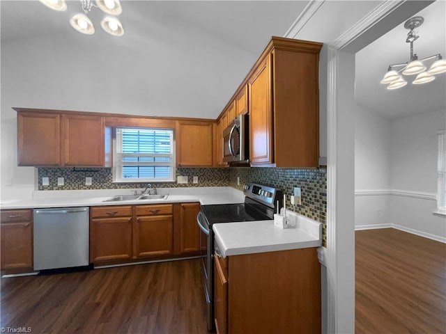 615 Walnut Crossing Dr, Whitsett, NC 27377 - kitchen featuring appliances with stainless steel finishes, a chandelier, a sink, dark wood finished floors, and lofted ceiling