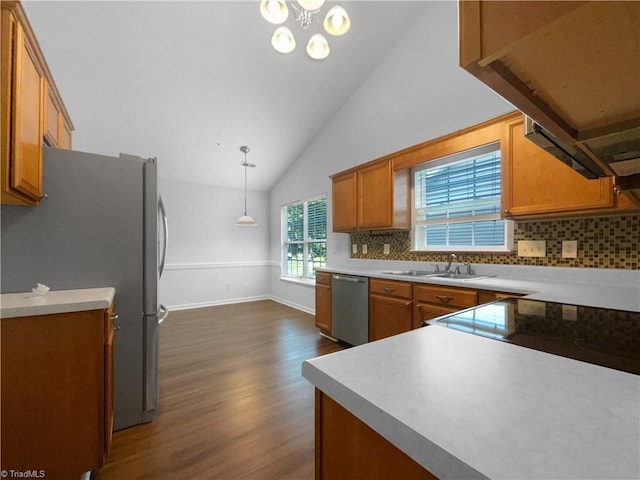 615 Walnut Crossing Dr, Whitsett, NC 27377 - kitchen featuring appliances with stainless steel finishes, brown cabinetry, dark wood finished floors, backsplash, and a sink