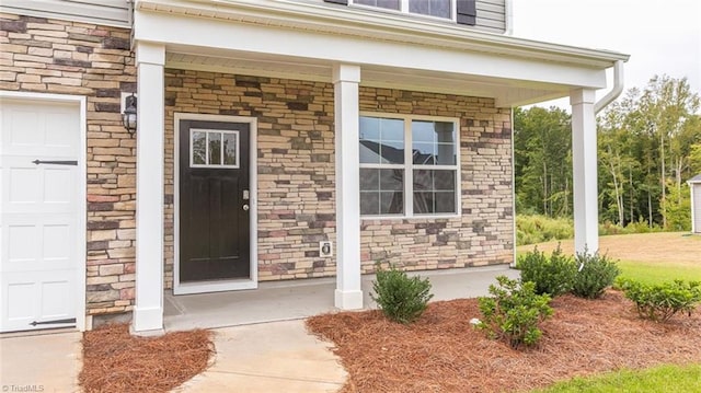 entrance to property with a porch and a garage