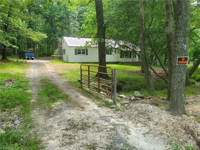 291 Virgil Hill Rd, Asheboro, NC 27205 - view of front of home with dirt driveway, metal roof, and a gate