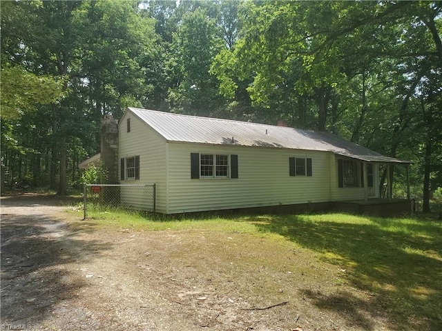 291 Virgil Hill Rd, Asheboro, NC 27205 - view of side of home with a chimney, metal roof, and driveway