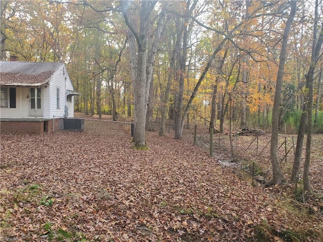 291 Virgil Hill Rd, Asheboro, NC 27205 - view of yard with central AC unit, a forest view, and covered porch
