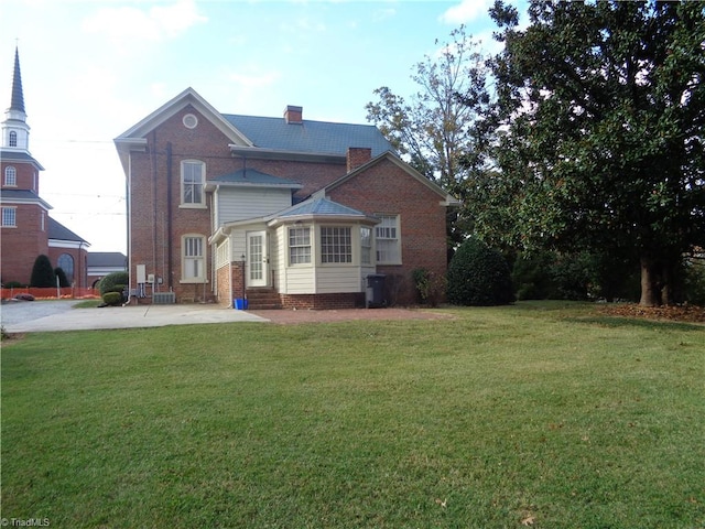 rear view of house with a lawn