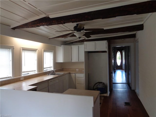 kitchen with ceiling fan, beam ceiling, plenty of natural light, and kitchen peninsula