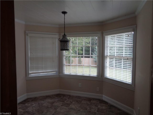 unfurnished dining area with crown molding and dark tile flooring