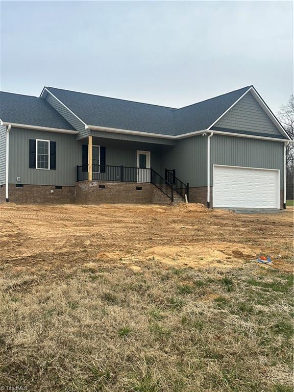 ranch-style home featuring roof with shingles, crawl space, and an attached garage