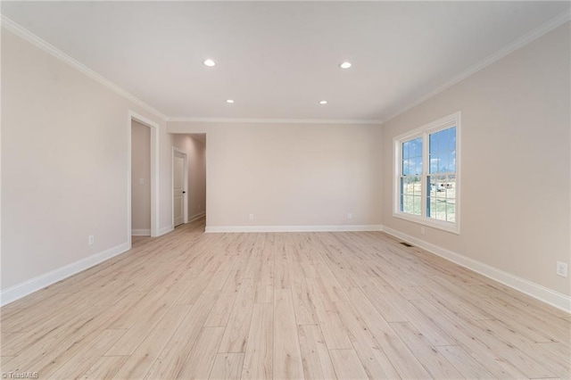 unfurnished room with crown molding, light wood-style flooring, and baseboards