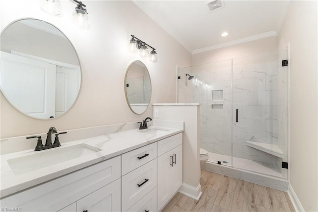 bathroom featuring ornamental molding, a sink, and visible vents