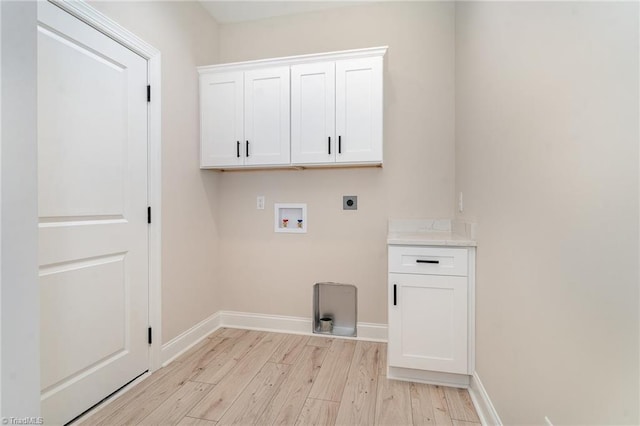 laundry area featuring hookup for a washing machine, baseboards, light wood-style floors, cabinet space, and electric dryer hookup