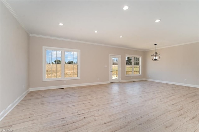 unfurnished living room featuring crown molding, light wood finished floors, and a healthy amount of sunlight