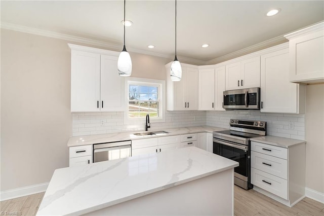 kitchen featuring decorative backsplash, appliances with stainless steel finishes, ornamental molding, a kitchen island, and a sink