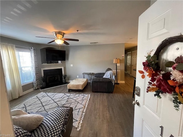 living room with ceiling fan and dark hardwood / wood-style floors