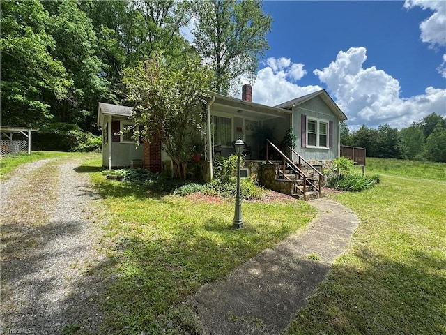 4679 S NC Highway 18, Moravian Falls, NC 28654 - view of front facade featuring a chimney, driveway, and a front lawn