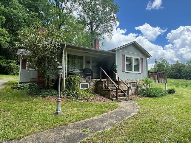 4679 S NC Highway 18, Moravian Falls, NC 28654 - view of front facade featuring a front lawn, a chimney, a porch, and stairs