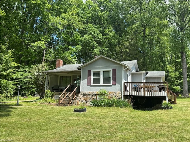 4679 S NC Highway 18, Moravian Falls, NC 28654 - view of front facade featuring a front lawn, a wooden deck, a chimney, and stone siding