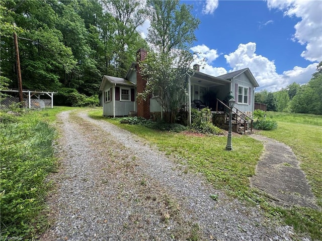 4679 S NC Highway 18, Moravian Falls, NC 28654 - view of front facade with driveway and a chimney