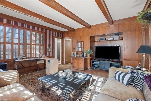 living room with wooden walls and beamed ceiling