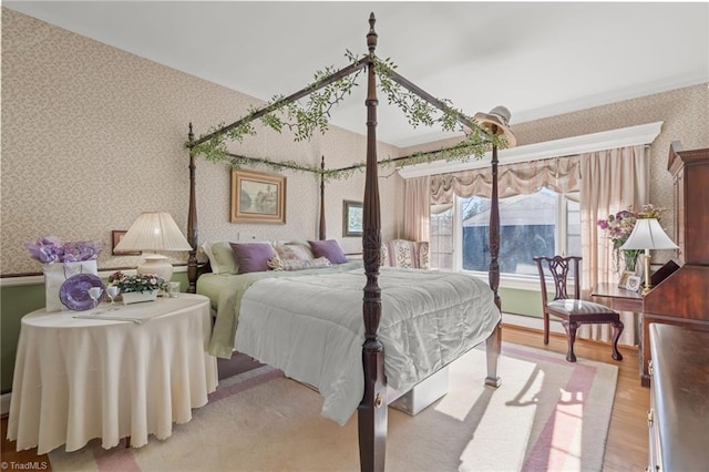 bedroom featuring hardwood / wood-style flooring and crown molding