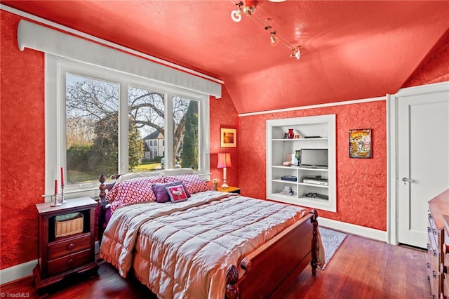 bedroom with hardwood / wood-style floors and vaulted ceiling