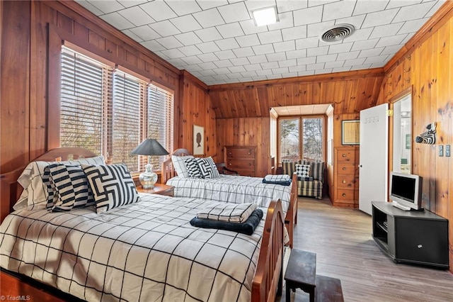 bedroom featuring crown molding and light hardwood / wood-style floors