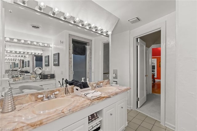 bathroom with tile patterned flooring and vanity