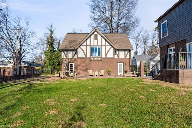 rear view of property featuring a yard and a patio