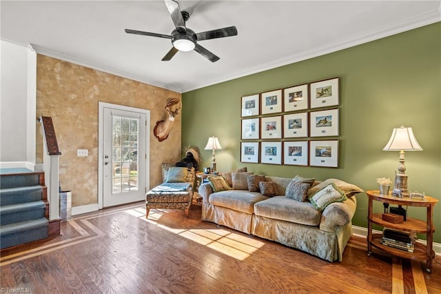 living room with wood-type flooring, ceiling fan, and ornamental molding