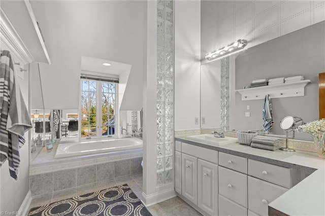 bathroom with vanity, tile patterned floors, and tiled tub