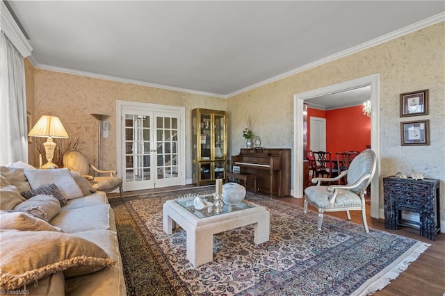 living room with hardwood / wood-style flooring, ornamental molding, and french doors