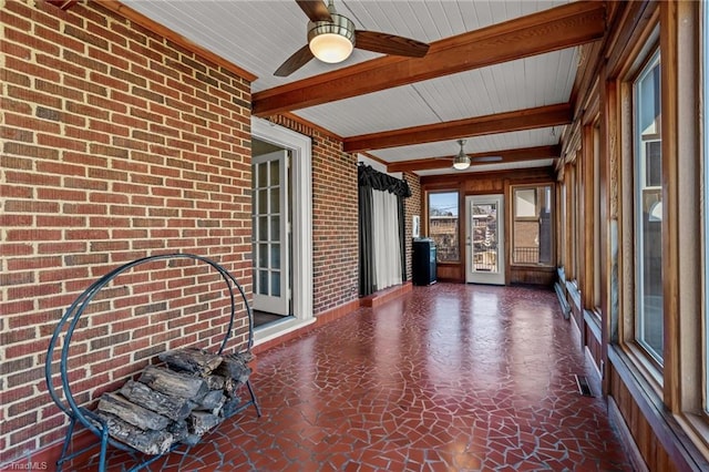 unfurnished sunroom with beam ceiling