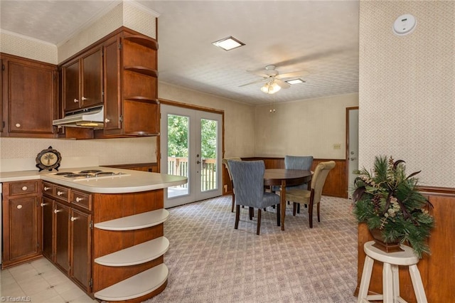 kitchen featuring white gas stovetop, french doors, kitchen peninsula, ceiling fan, and light tile patterned flooring