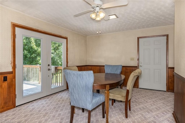 dining room with french doors, light colored carpet, and ceiling fan