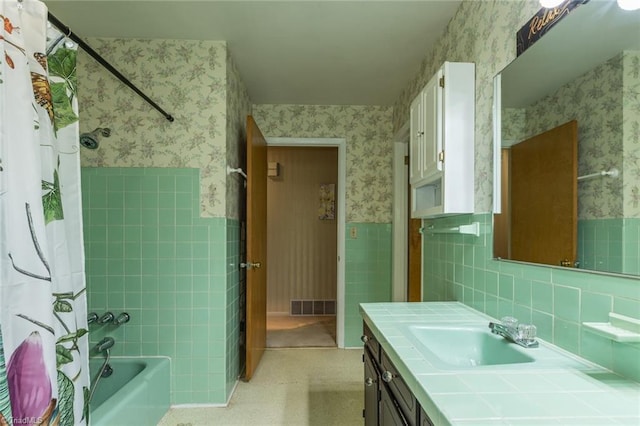 bathroom with vanity, tasteful backsplash, shower / tub combo with curtain, and tile walls